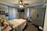 An additional bedroom with natural light and a ceiling fan.