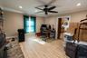 An alternate view of the the versatile space where the fireplace serves as a central focal point and the surrounding gathering space.