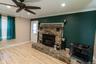 This versatile interior space with a stone fireplace is suitable for a variety of uses.