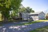 Generous driveway area with convenient access to the residence and barn surrounded by trees.