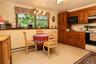 Second kitchen for mom with dual windows, custom cabinetry with pull oput shelving and dining area