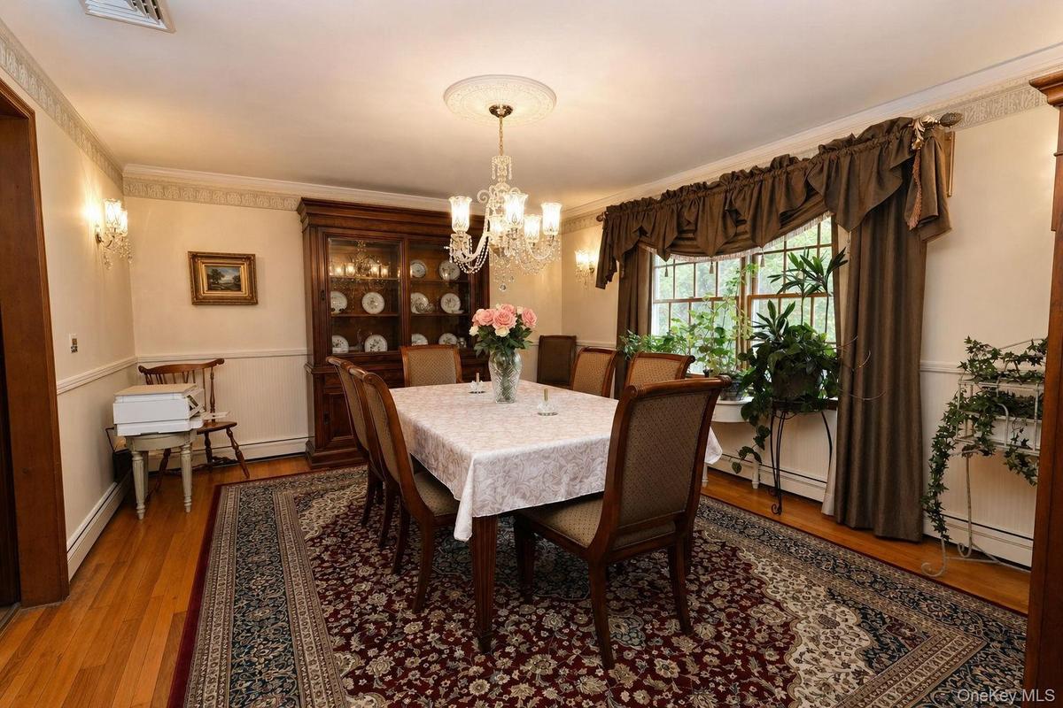 Hardwood flooring, dual windows, chandelier with ceiling medallion, wall sconces, crown molding and custom stenciling
