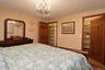 Recessed lighting, wood-finish doors, built-in shelving and walk-in closet