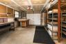 3 car garage with tool bench, electric panel and garage door openers