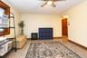 Neutral wall paint, wood-finish window trim, ceiling fan light fixture, and 6 panel wood doors,