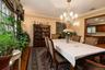 Hardwood flooring, decorative wall molding, crystal chandelier, built-in display cabinetry,  large window and custom stenciling