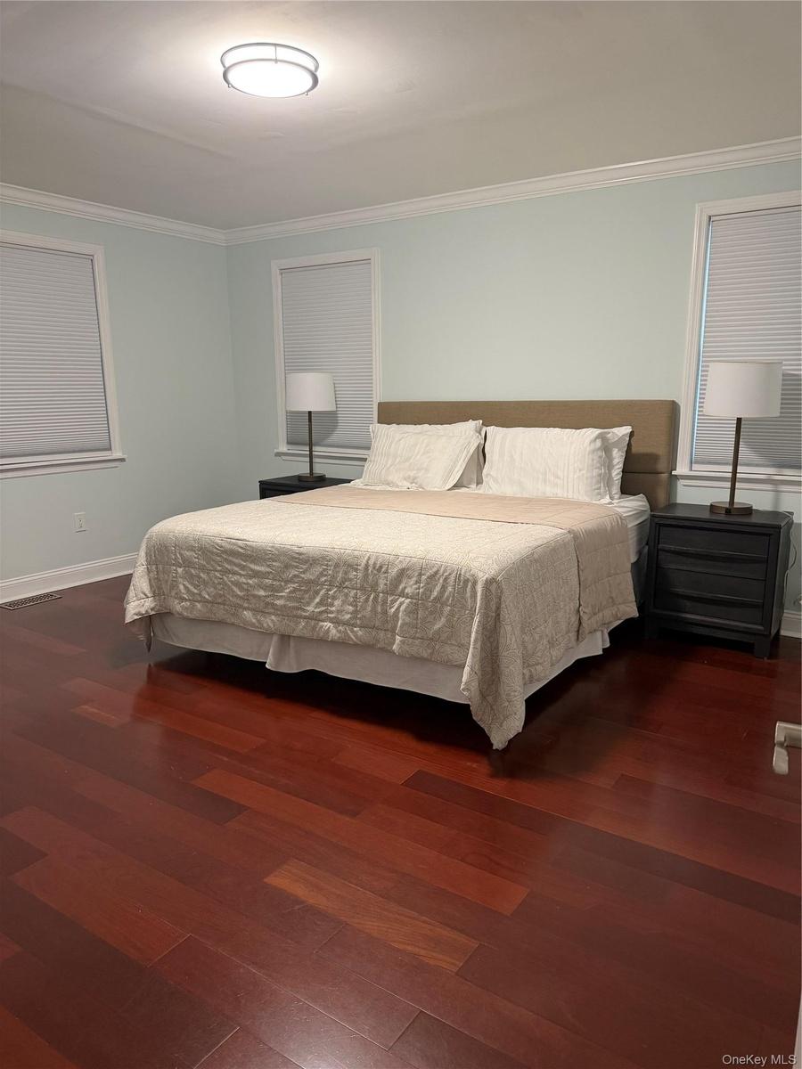 Unit 1 - Spacious Primary Bedroom with Walk-in Closet & Private Full Bathroom with Step-In Shower.