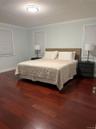 Unit 1 - Spacious Primary Bedroom with Walk-in Closet & Private Full Bathroom with Step-In Shower.