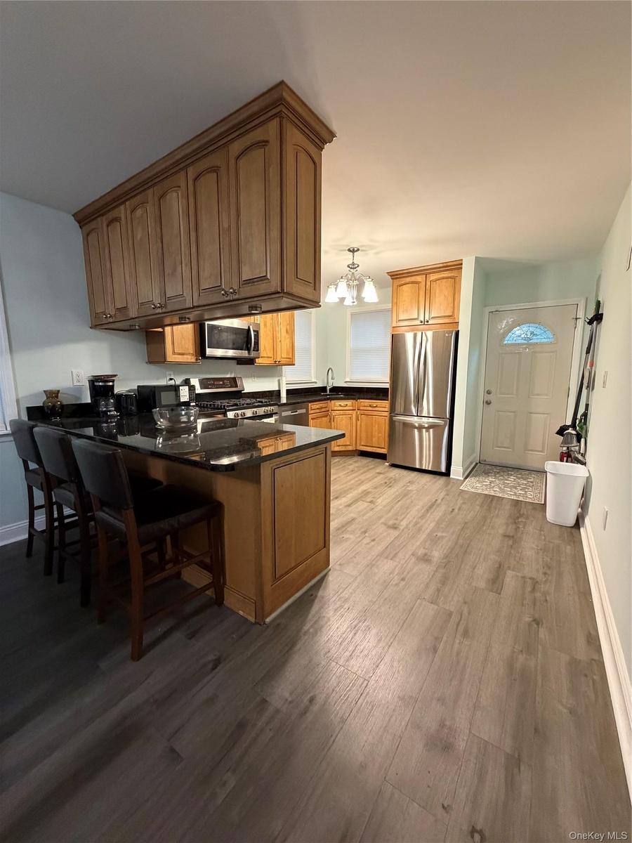 Unit 1 - Open Concept Kitchen with Exterior Door to Back Deck & Yard