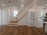 LIVINGROOM WITH FROSTED DOOR LEADING TO FULL BASEMENT