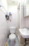 White tiled walls extending to the ceiling