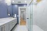 Primary Bathroom with Double Sinks and Carerra Marble vanity top and glass enclosure shower