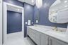 Primary Bathroom with Double Sinks and Carerra Marble vanity top, water closet with linen storage