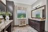 Primary En-suite Bathroom w/Framed Mirrors & Crown Molding