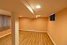 This additional bedroom offers versatile uses with recessed lighting and abundant light.