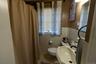 The bathroom features natural light and a timeless vanity.