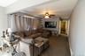 Comfortable living area featuring a ceiling fan, multiple windows and natural light