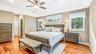 Tray ceiling with a ceiling fan, recessed lighting, and wood-finish flooring