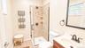 En Suite One - single sink vanity, glass shower tith detailed tile, radiant heated floor