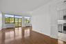 Living Room with Door to Terrace and Tree Top/Sky line View with Beautiful Hardwood Floors