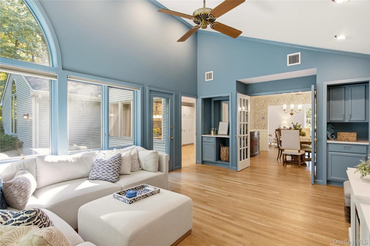 Vaulted ceilings, dry bar, built ins and door to deck in backyard