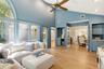 Vaulted ceilings, dry bar, built ins and door to deck in backyard
