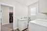 Laundry room off primary bed closet