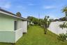 side yard with fruit trees and garage access door