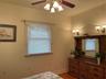 2nd bedroom has brass ceiling fan and recessed lighting.