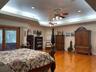 Extra large primary bedroom has plenty of room for large bedroom furnishings and a sitting area