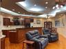 Living room and kitchen has lots of recessed lighting.