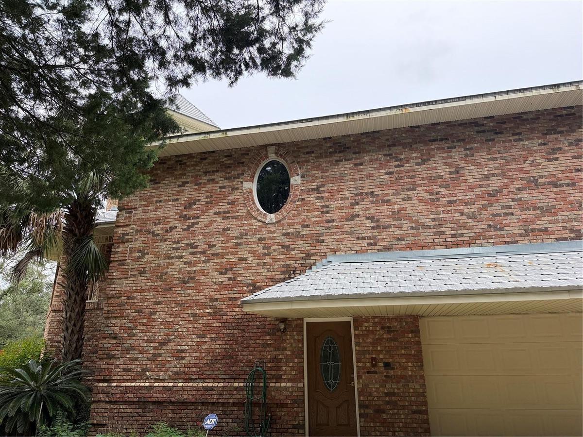 Garage, front entry door,oval window is in primary bathroom