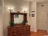 2nd bedroom features four sconse lights.