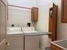 Washer, dryer and stand up sink in laundry room on second floor
