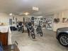 The garage and workshop square footage is approximately 2,075 sq ft. Which does not include the additional two utility rooms