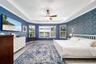 Primary bedroom with beautiful views and elegant designer wallpaper.