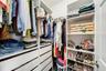 Large walk-in closet with plenty of storage.