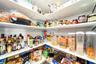 Convenient walk-in pantry with plenty of room for kitchen essentials.