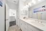 Bathroom with a spacious dual-sink vanity and tub-and-shower combination.