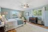 A restful retreat with windows on two walls, leafy views, and generous space to make the primary bedroom your own.