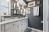 Start your day with generous vanity space, plentiful drawer storage, and pendant lighting that adds a stylish touch to the primary bath.