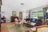 A generous front window frames leafy views and fills this welcoming gathering space with natural light.