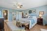 Unwind in a generously sized primary suite with warm wood flooring and the everyday convenience of a private ensuite bath.