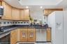Everything within reach, with wraparound counters, plentiful cabinet storage, and a convenient pass-through connecting the kitchen to the family room.