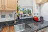 Stay part of the conversation while preparing meals, with an open pass-through overlooking the bright family room and its leafy backyard views.