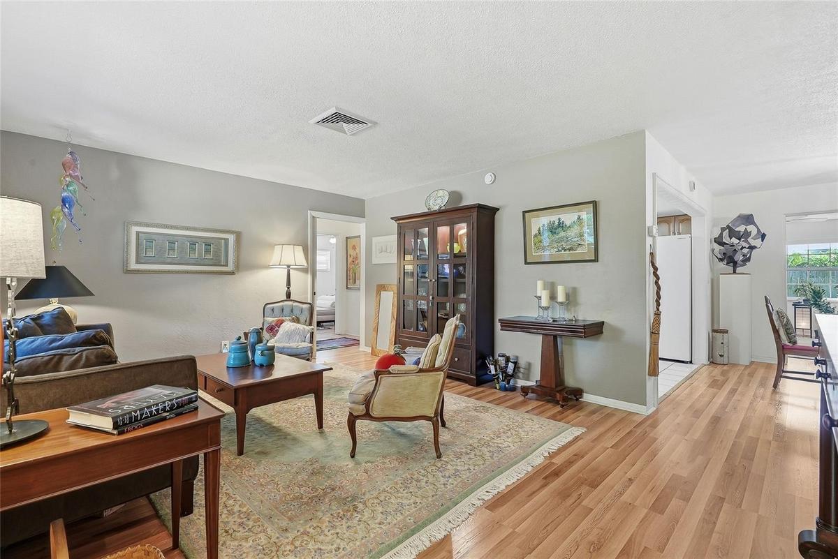 Room to gather and unwind. The spacious living room offers flexible furniture arrangements and easy access to the kitchen, dining area and guest bedro