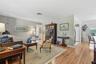 Room to gather and unwind. The spacious living room offers flexible furniture arrangements and easy access to the kitchen, dining area and guest bedro