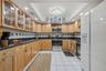 Spread out and create in a kitchen featuring generous counter space, abundant cabinetry, and glass-front cabinets to showcase your favorite pieces.