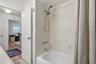 Enjoy the flexibility of a full tub and shower combination, finished with classic white tile and a handheld showerhead.