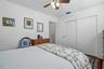 A wide closet with sliding doors provides convenient storage while preserving floor space for your bedroom furnishings.